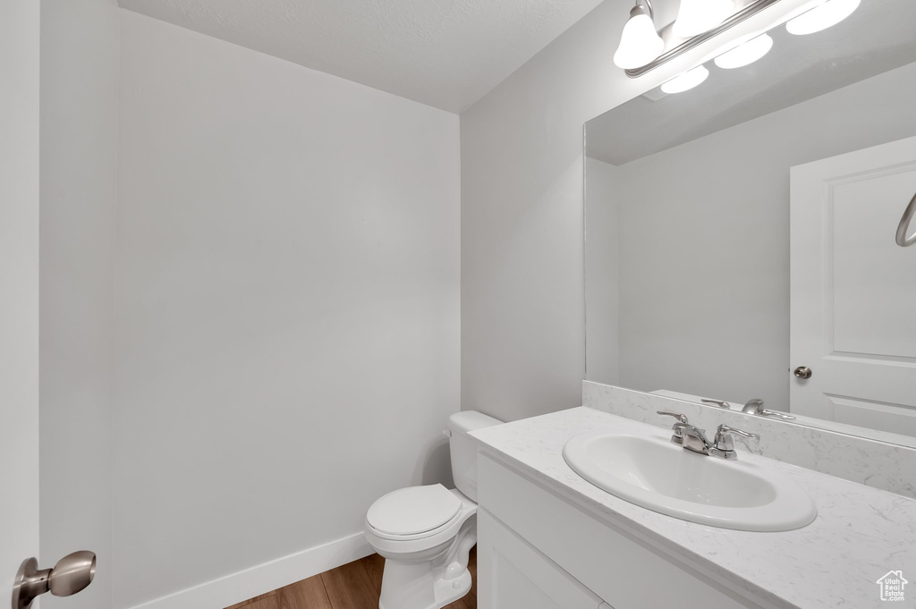Bathroom featuring vanity and wood finished floors