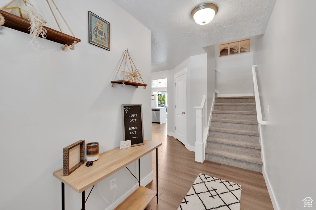 Foyer with wood finished floors and stairs
