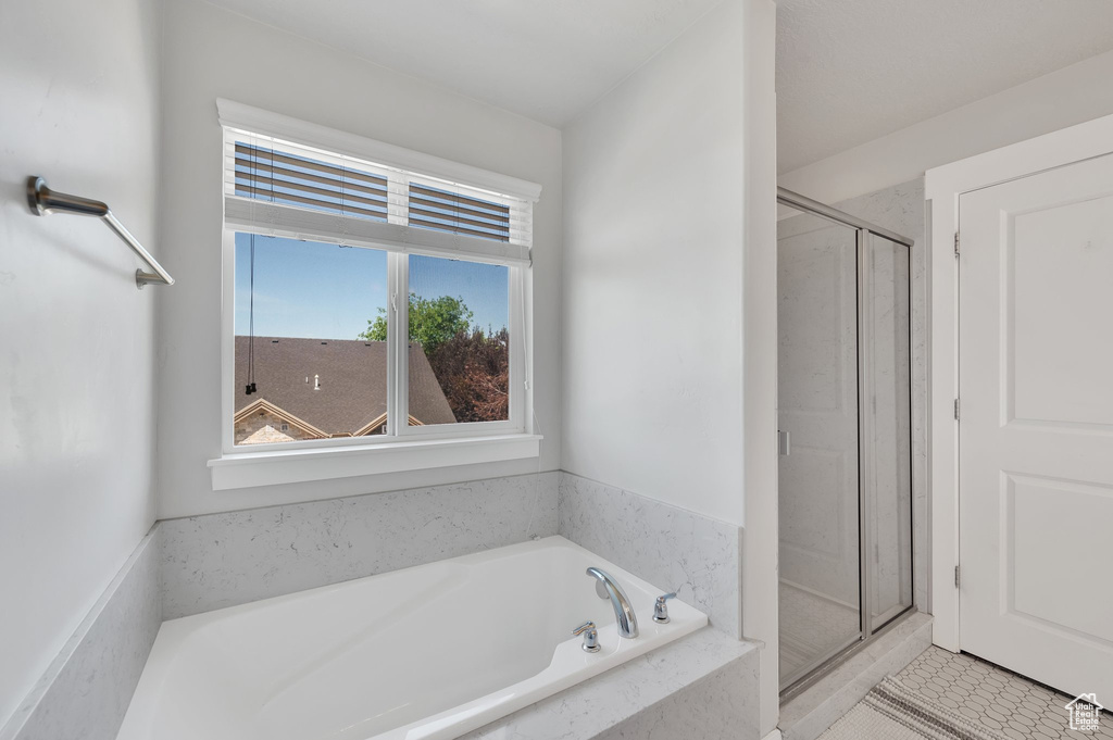 Bathroom with a shower stall and a garden tub