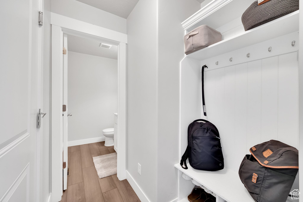 Mudroom featuring wood finished floors and baseboards