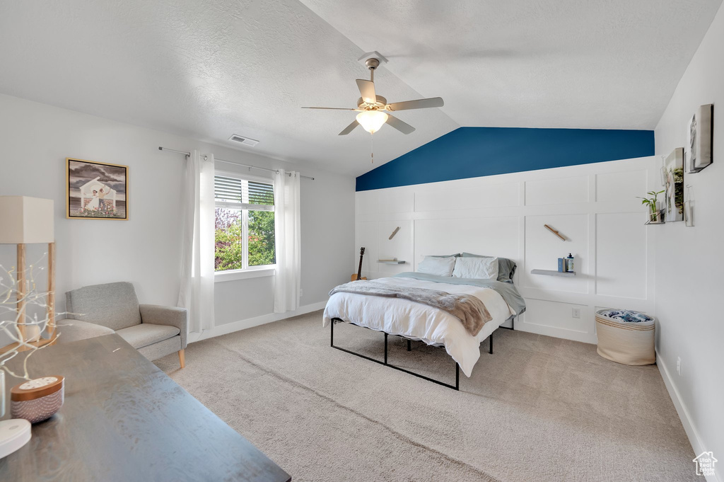 Bedroom featuring lofted ceiling, carpet, and a ceiling fan
