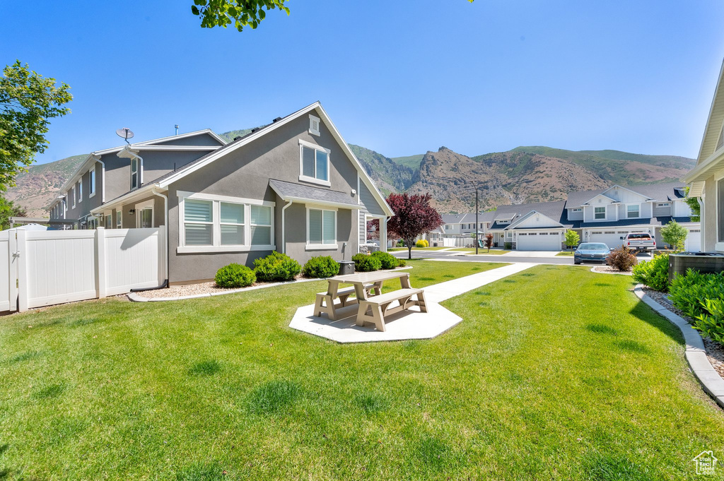 Back of property with stucco siding, a mountain view, and a residential view