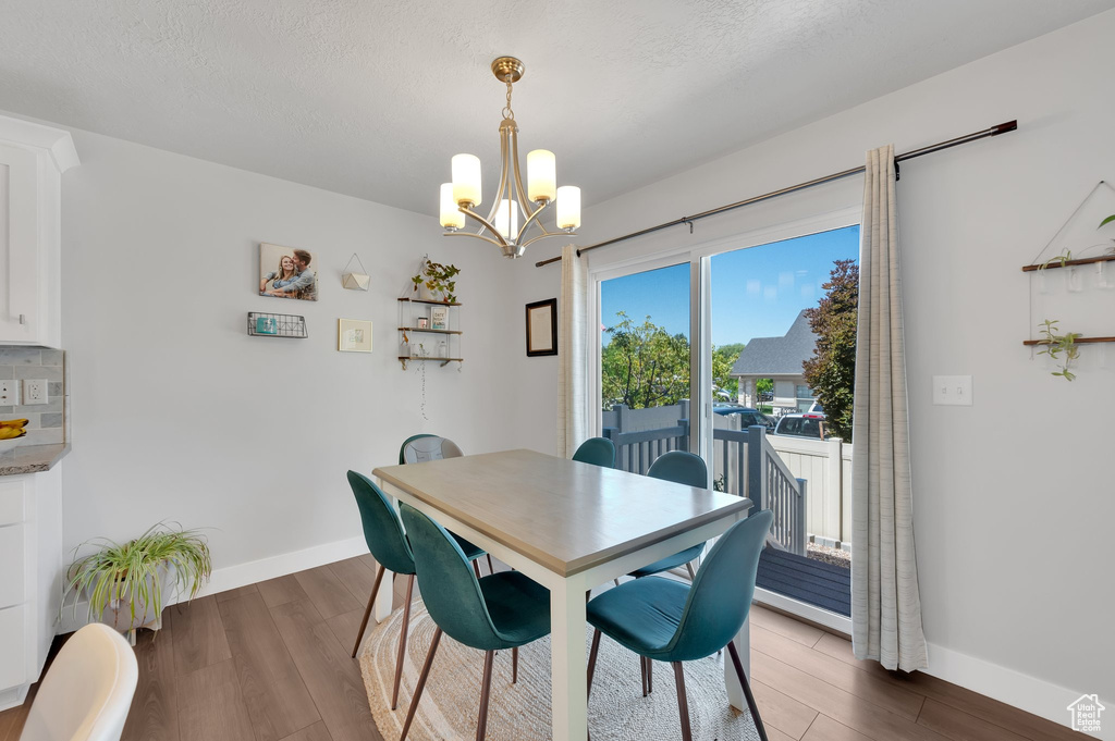 Dining room with a chandelier and wood finished floors