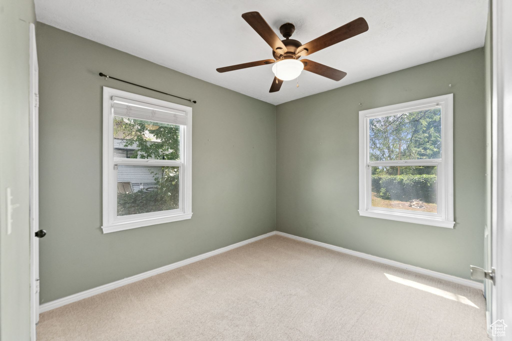 Spare room with carpet flooring and a ceiling fan