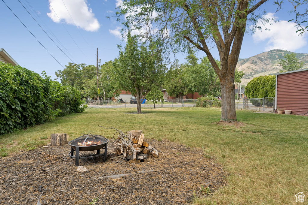 View of yard with a fire pit and a mountain view