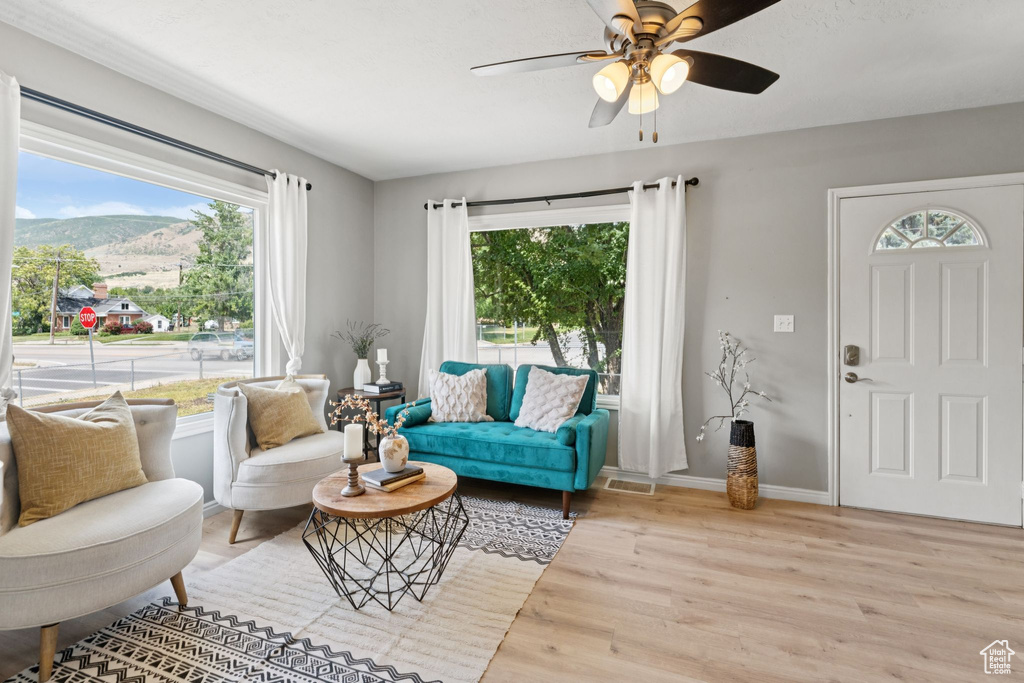 Living room with wood finished floors, healthy amount of natural light, and a mountain view
