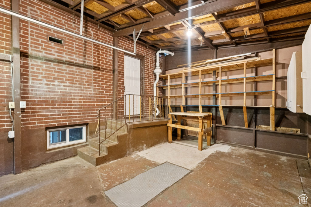 Unfinished below grade area featuring stairs