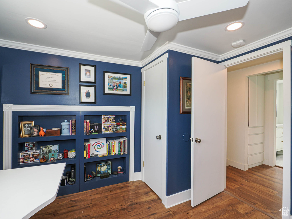 Rec room featuring crown molding, wood finished floors, and recessed lighting