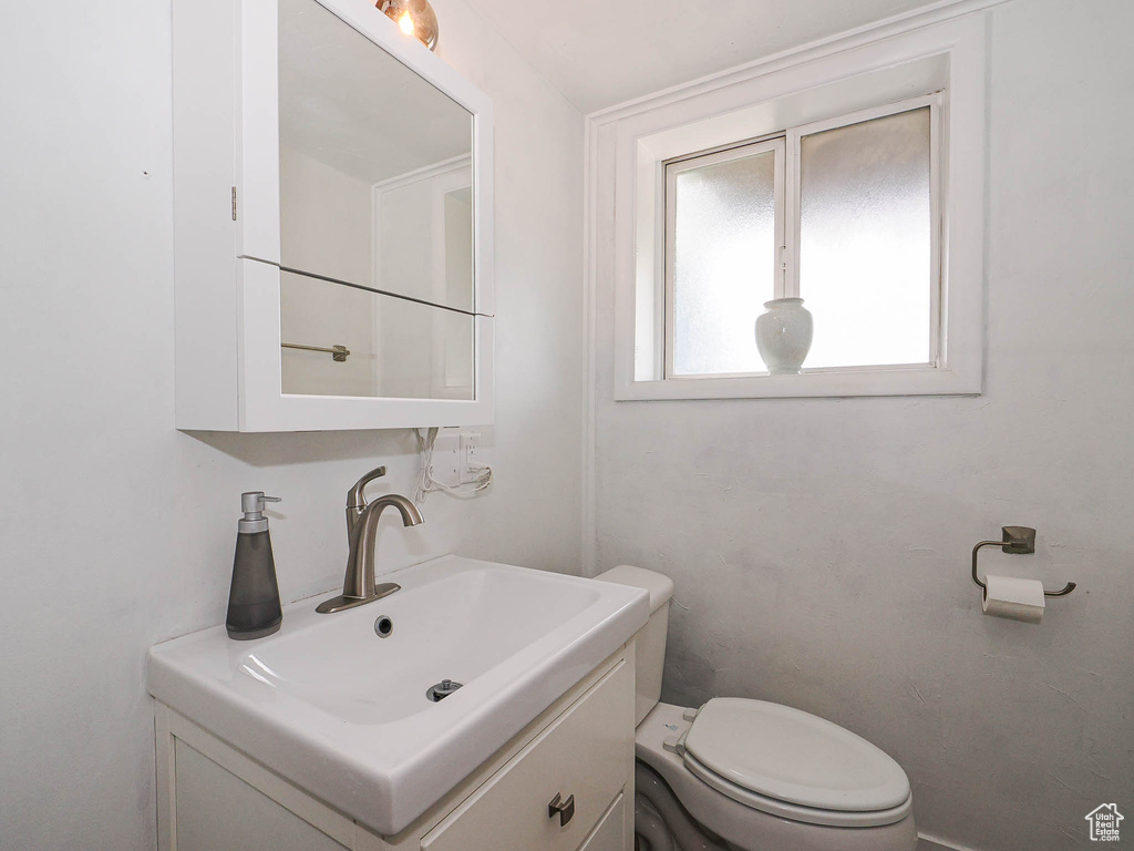 Half bath with vanity and toilet