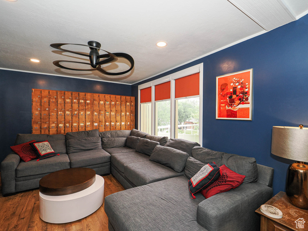 Living area with wood finished floors, recessed lighting, and ceiling fan