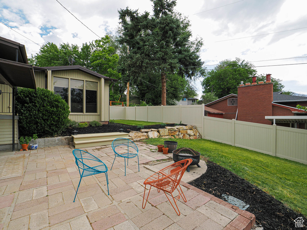 View of patio featuring an outdoor fire pit