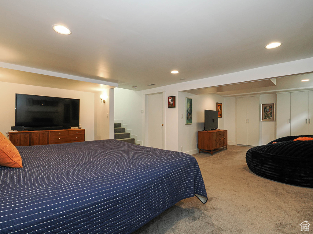 Carpeted bedroom with recessed lighting