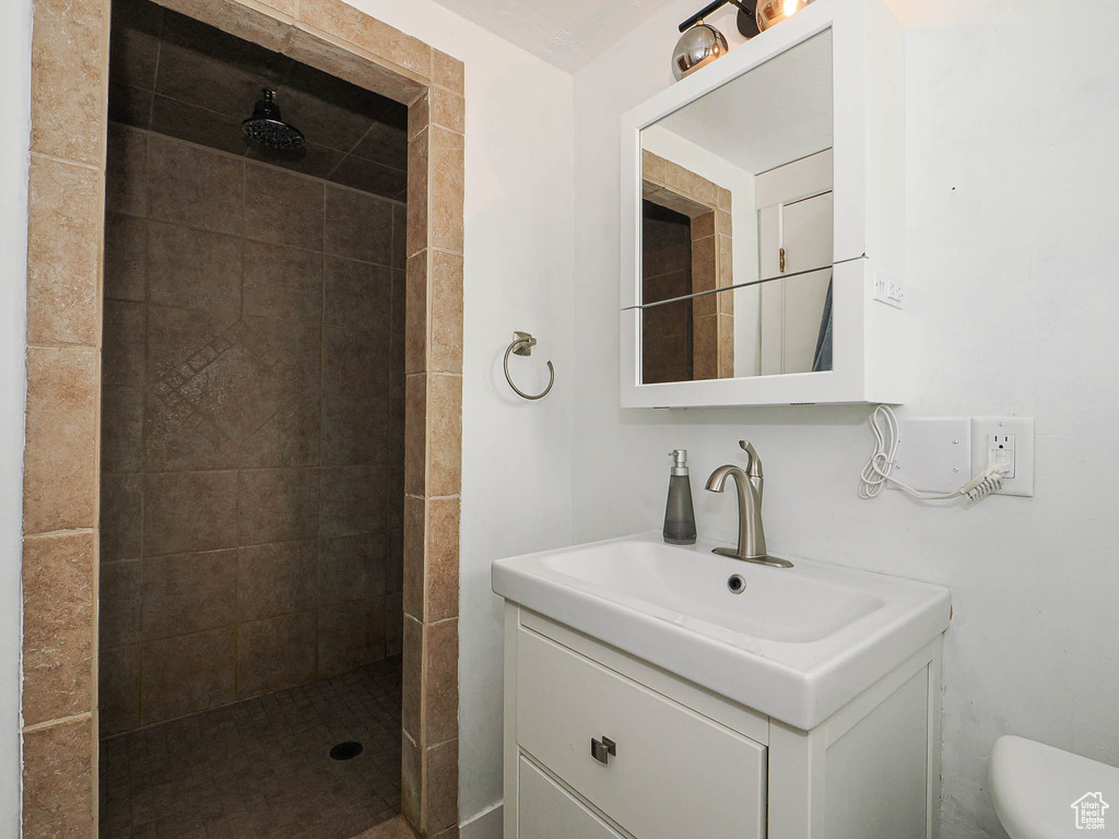 Bathroom featuring vanity and tiled shower
