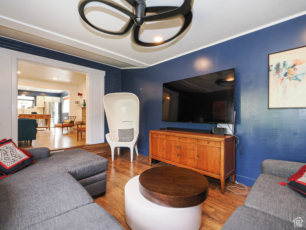 Living area with wood finished floors and baseboards