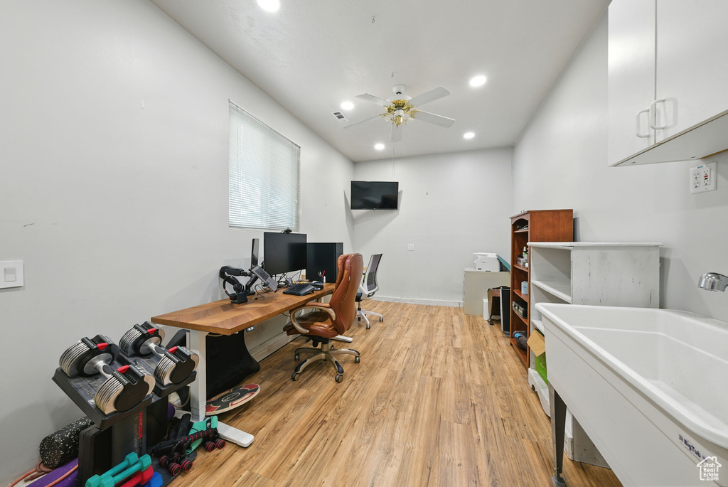 Home office with light wood-style floors, ceiling fan, and recessed lighting