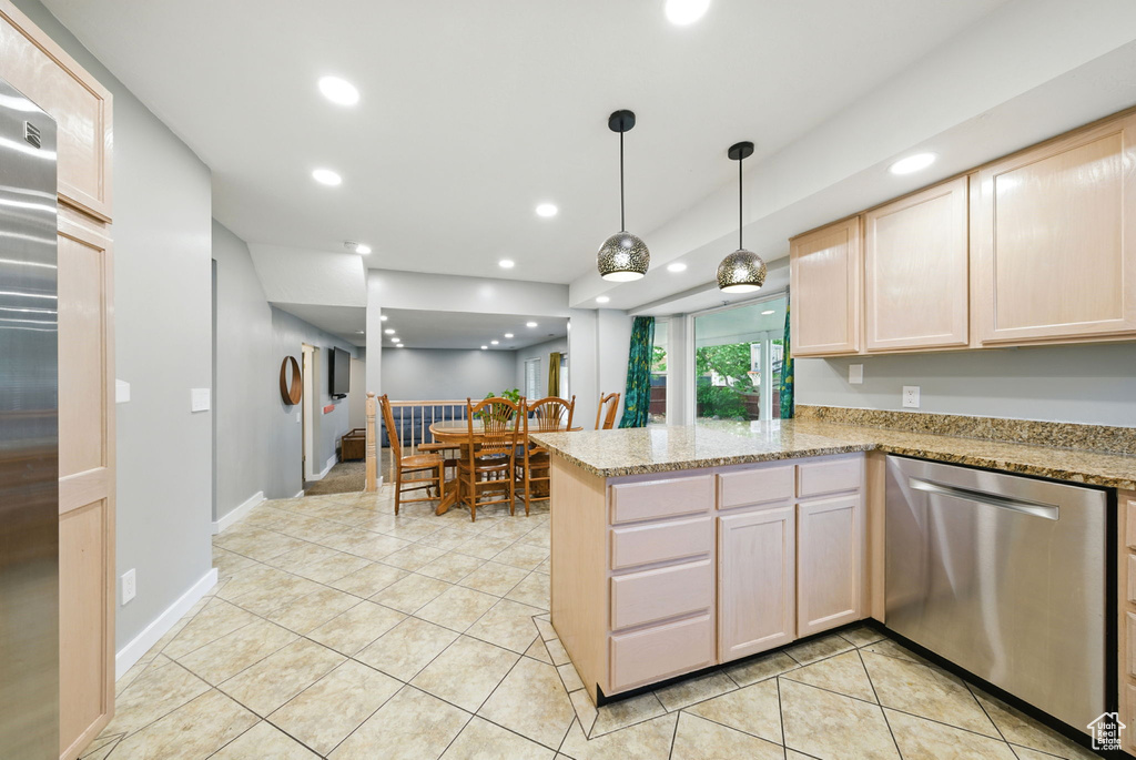 Kitchen with stainless steel appliances, light brown cabinets, a peninsula, light tile patterned floors, and recessed lighting