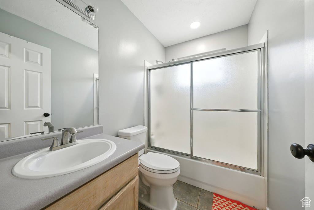 Full bathroom with vanity and combined bath / shower with glass door