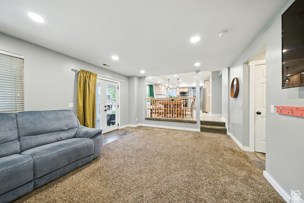 Living area with recessed lighting and carpet flooring