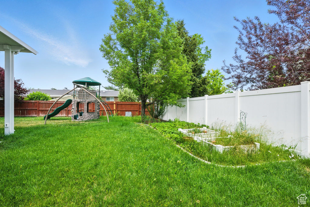 Fenced backyard with a playground