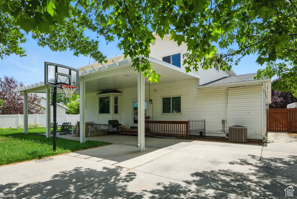 Rear view of house featuring a patio and a carport