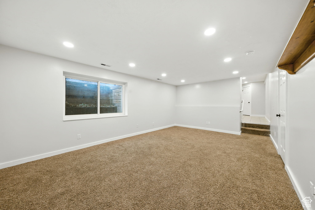Empty room featuring carpet flooring and recessed lighting