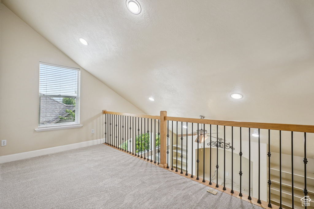 Hall with lofted ceiling, recessed lighting, and carpet floors