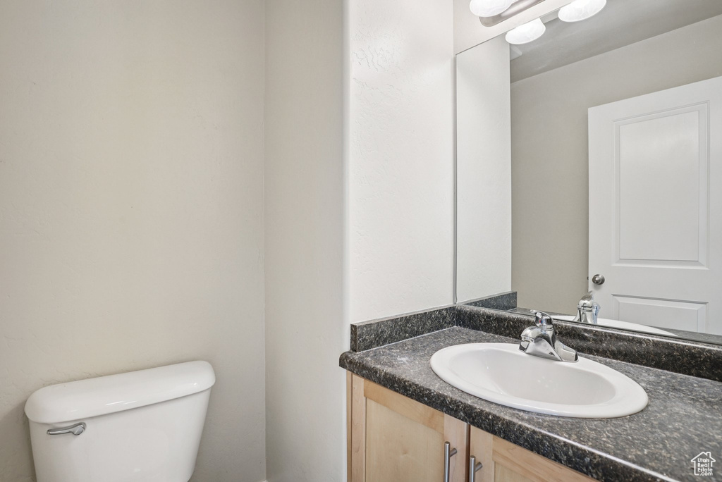 Half bathroom featuring toilet and vanity