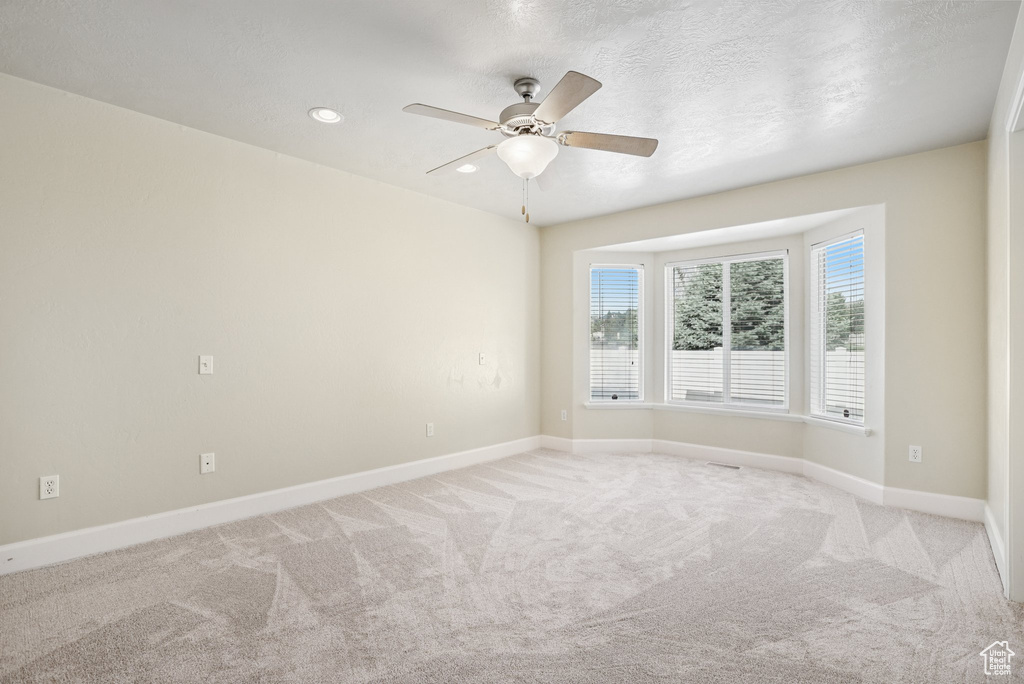 Unfurnished room featuring ceiling fan, recessed lighting, and light carpet