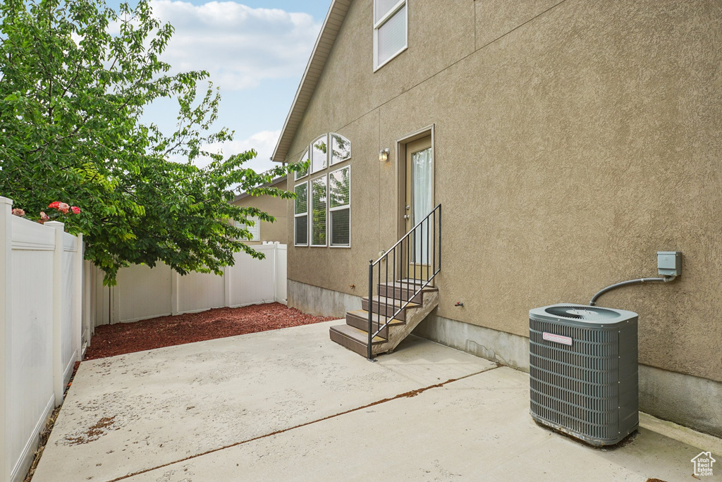 Fenced backyard with entry steps and a patio area