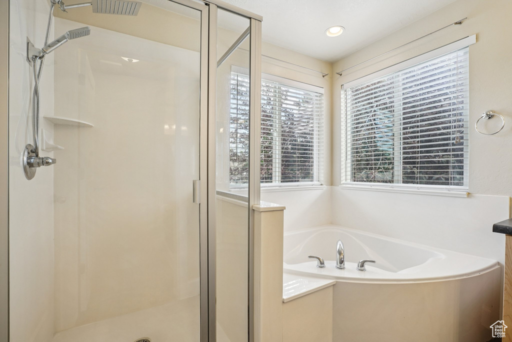 Full bath featuring a shower stall, a garden tub, and recessed lighting