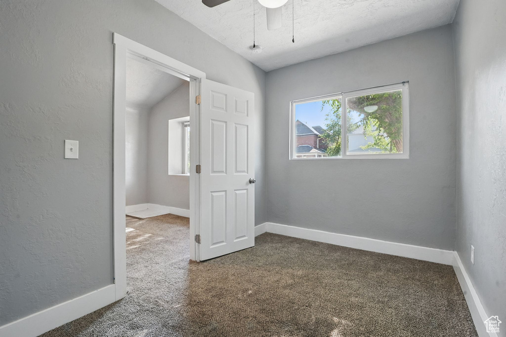 Spare room featuring carpet flooring and a ceiling fan