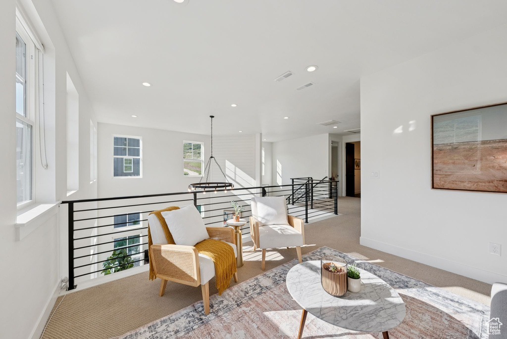 Sitting room featuring an upstairs landing, carpet flooring, and recessed lighting