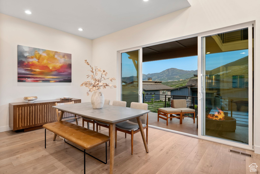 Dining area featuring light wood-style floors, a mountain view, and recessed lighting