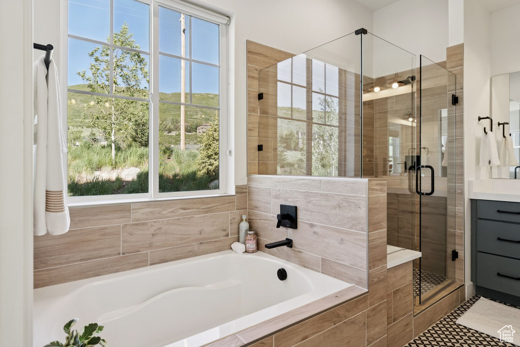 Bathroom with a bath, a shower stall, and vanity