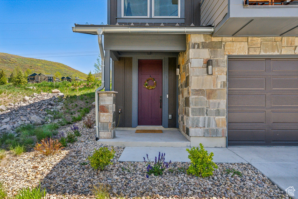 Doorway to property featuring a mountain view and stone siding