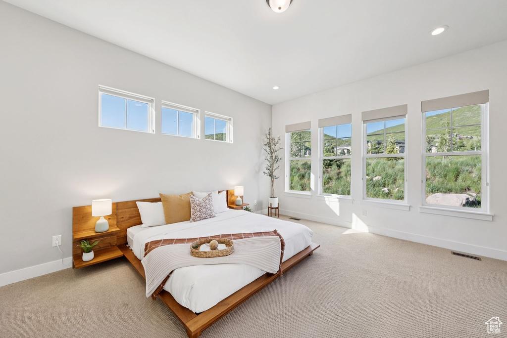Bedroom with light carpet and recessed lighting