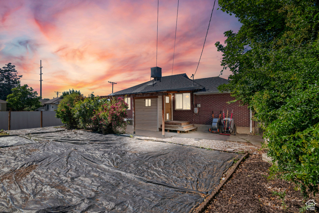 Back of house with brick siding and a patio area