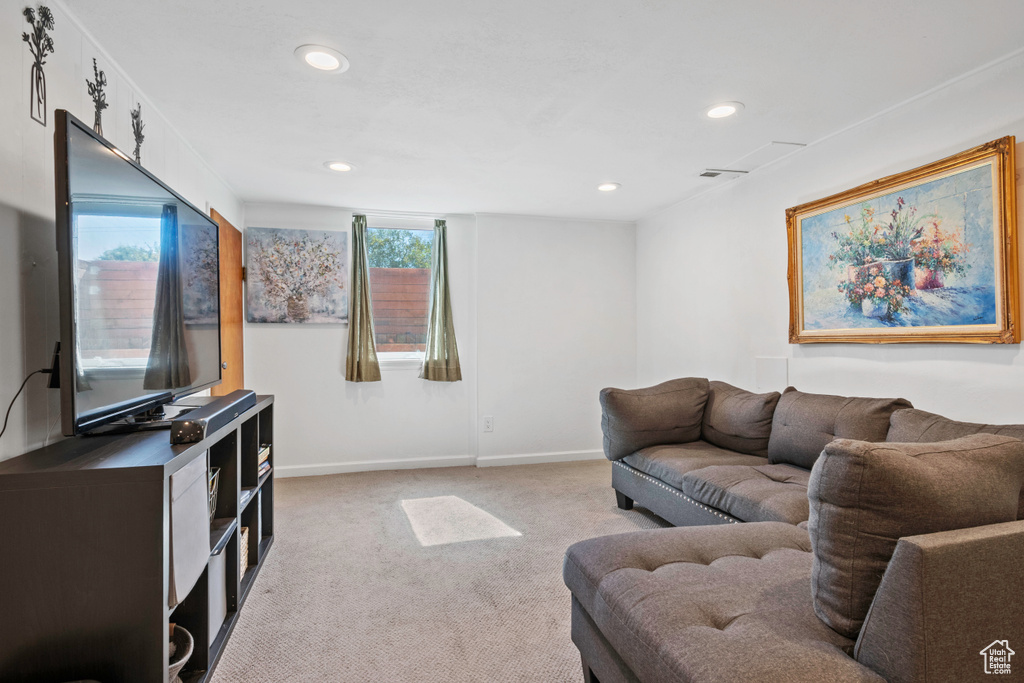 Living area featuring light colored carpet, recessed lighting, and baseboards
