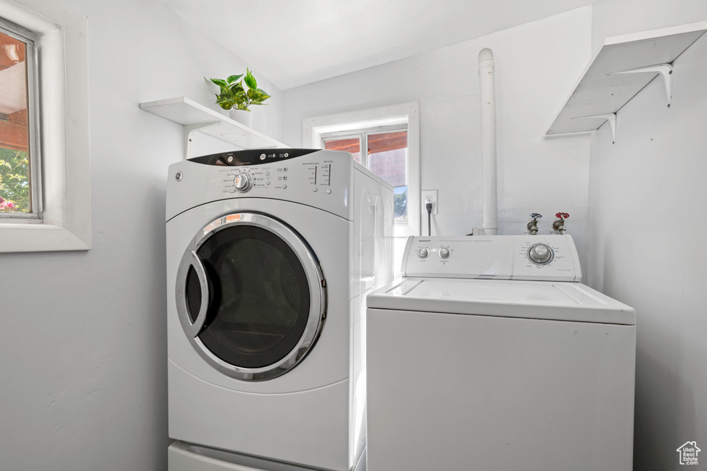 Washroom featuring washing machine and dryer