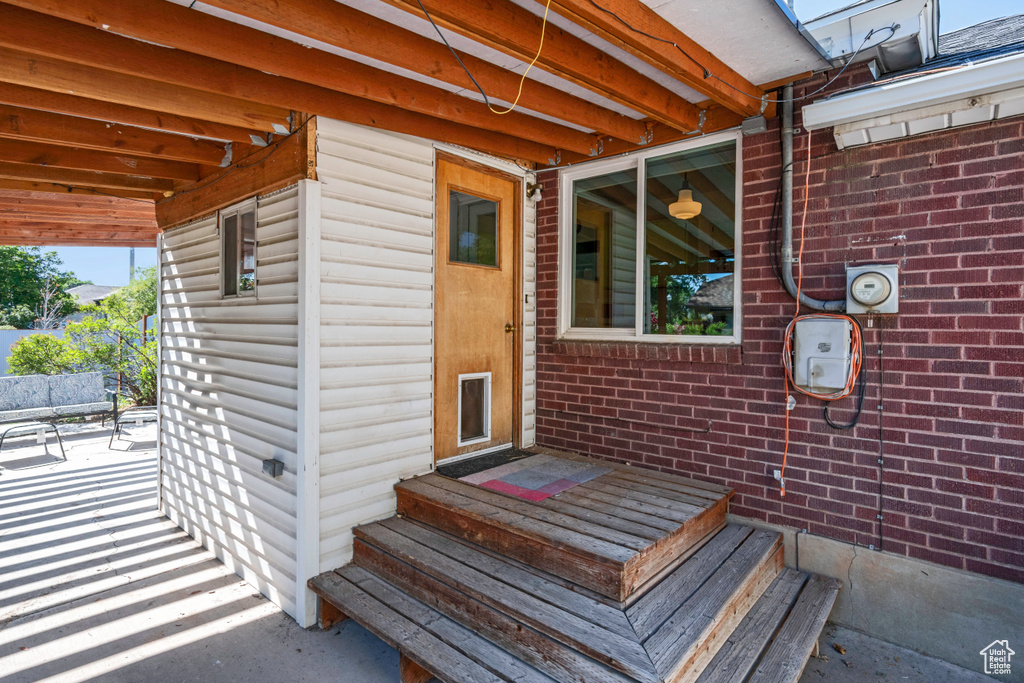 Doorway to property with brick siding