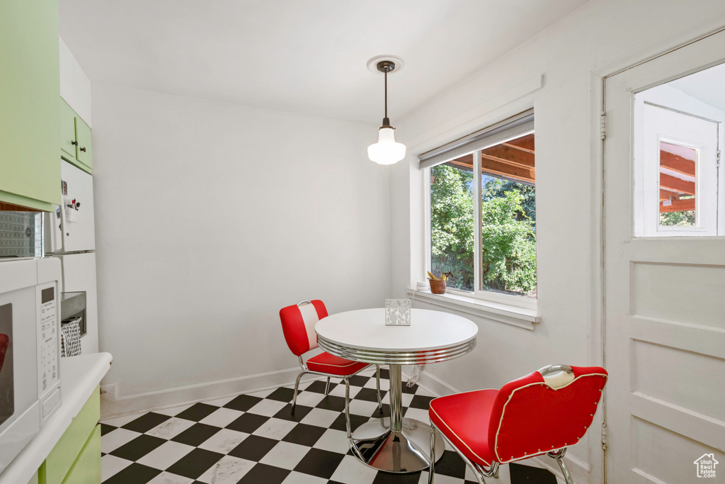 Dining space with tile patterned floors and baseboards