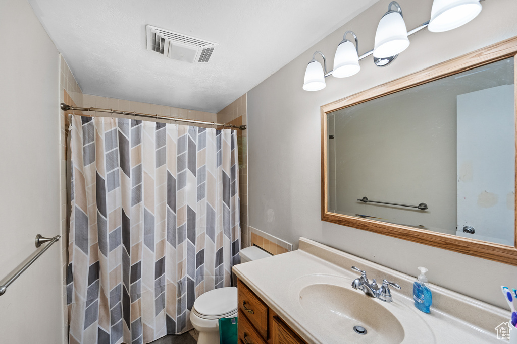 Bathroom featuring vanity and a shower with shower curtain