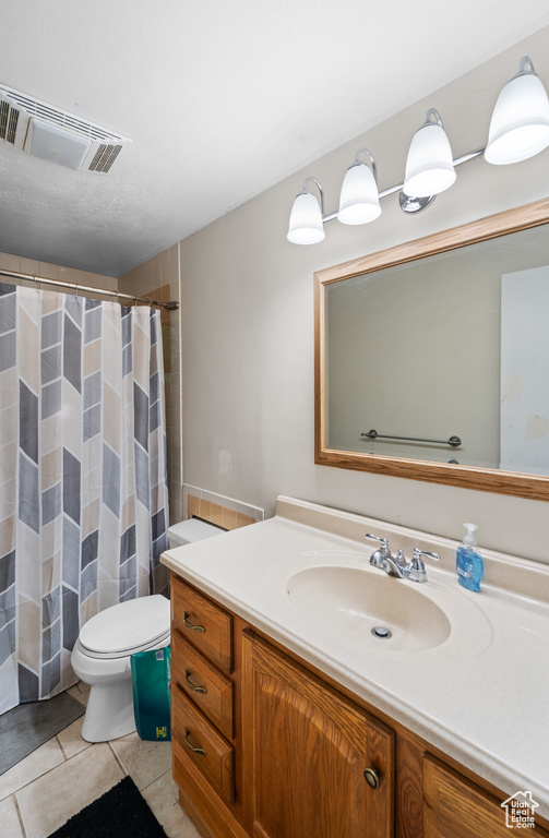 Bathroom with vanity, tile patterned flooring, and a shower with shower curtain