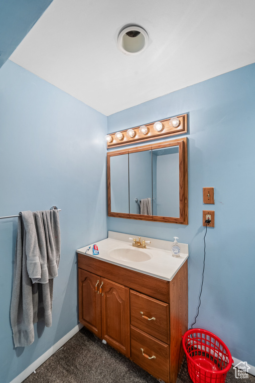 Bathroom featuring vanity and baseboards