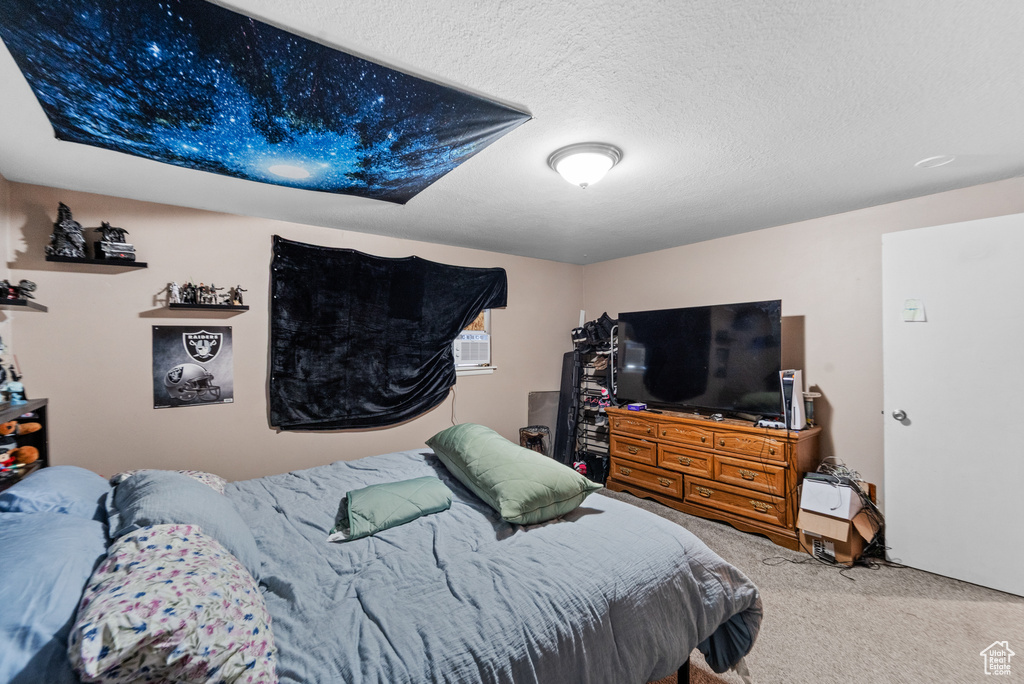 Carpeted bedroom featuring a textured ceiling