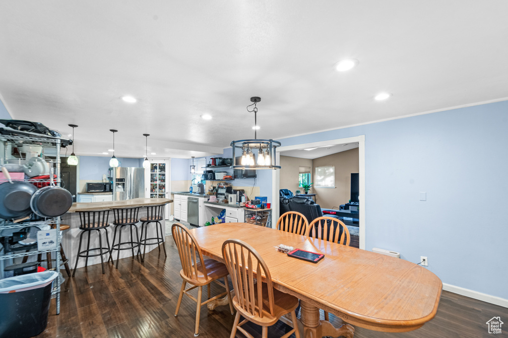 Dining area featuring dark wood-style flooring and recessed lighting