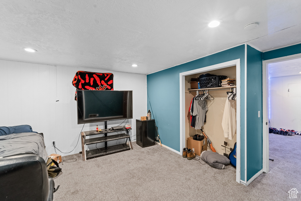 Bedroom with carpet floors, recessed lighting, a closet, and a textured ceiling