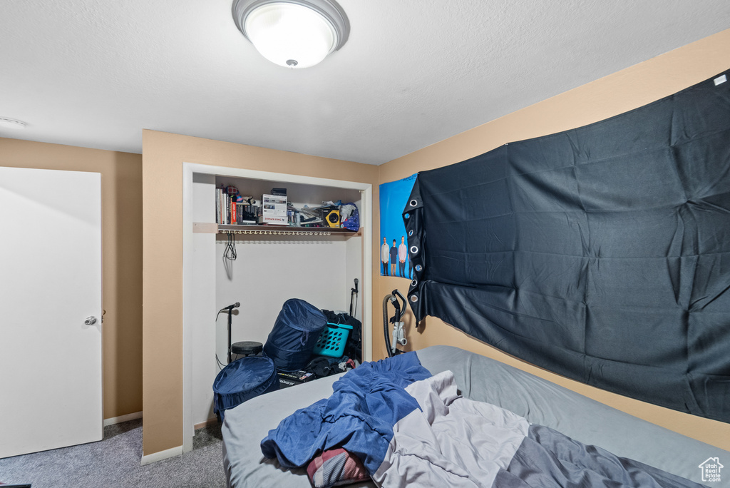 Bedroom featuring carpet floors and baseboards
