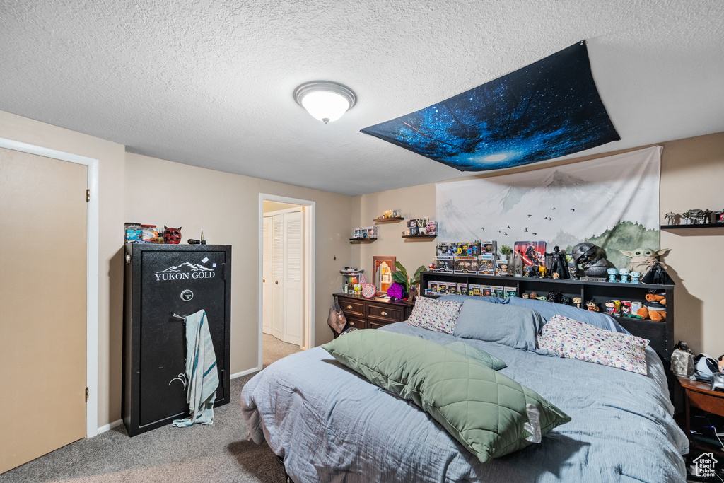 Bedroom with carpet and a textured ceiling