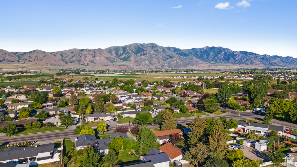 Aerial overview of property\'s location featuring a mountain backdrop and nearby suburban area